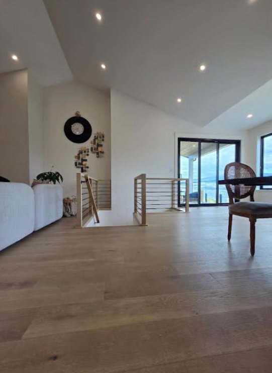 Hallway and stair landing with clean white walls and painted railings